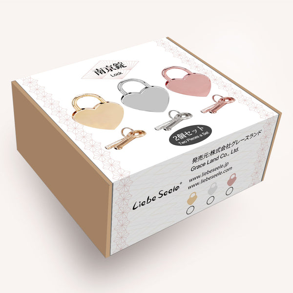 Liebe Seele heart-shaped locks in gold, silver, and rose gold displayed on product packaging with brand logo and Japanese text for BDSM accessories