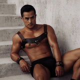 Man wearing luxury dark brown leather chest harness and wrist cuffs from The Equestrian BDSM collection, perfect for fetish wear and pony play roleplay
