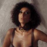 Woman modeling a luxurious leather posture collar from The Equestrian collection, featuring vintage gold hardware and dual-brown quilted leather