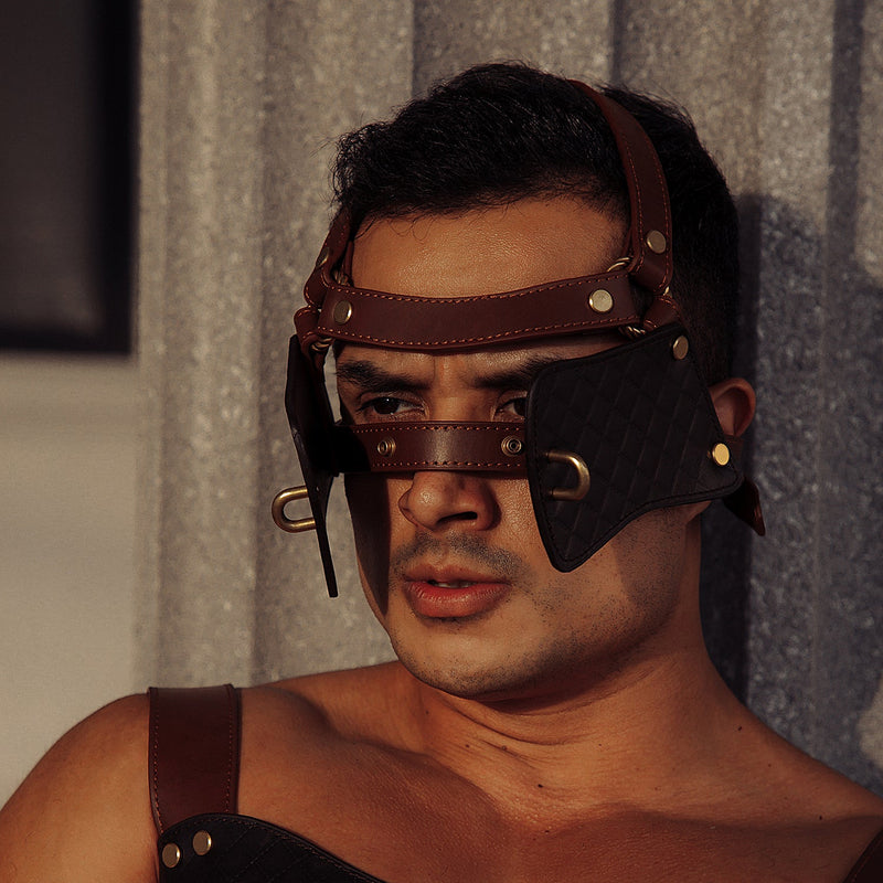 Man wearing The Equestrian leather blinder and gag for pony play, featuring dark and light brown leather and vintage gold metal details