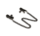 Black metal nipple clamps with connecting chain for bondage play