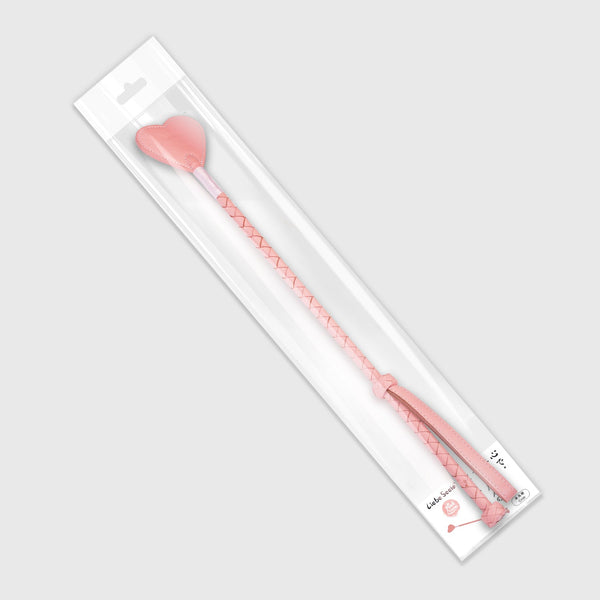 Pink Dream leather riding crop with heart shape tip in clear packaging, featuring braided handle and wrist loop for BDSM play