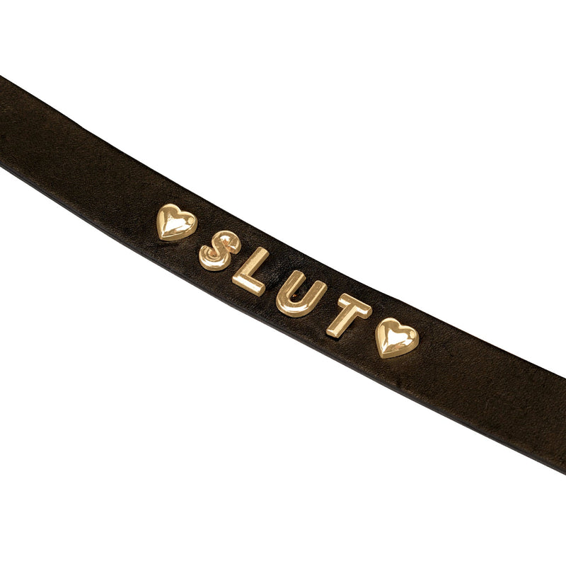 Gold Word Choker with 'SLUT' in gold letters on black leather, accented with golden heart charms