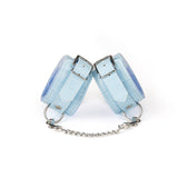Sky-blue faux crocodile leather handcuffs with silver buckles and chain, part of a beginner's bondage kit