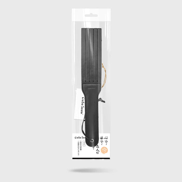 Dual-sided Dark Secret Leather Spanking Paddle in clear packaging, featuring a wrist loop and high-end leather, from Liebe Seele's BDSM collection