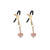 Gold heart-shaped nipple clamps with floral design on white background and rubber coated tips for comfort