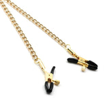 Gold metal chain and adjustable bull nose nipple clamps with black rubber tips for BDSM play