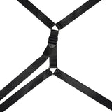 Black under mattress restraint system with cross pattern webbing belts and central buckle for bondage play