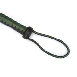 Close-up of dark green and black leather Cat O Nine Tails whip with braided handle and loop for BDSM play