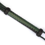 Close-up of mossy chic leather cat o' nine tails whip with green and black braided handle and leather caps