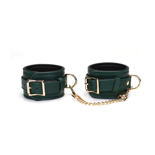 Mossy Chic Leather Wrist Cuffs with gold hardware, showcasing adjustable straps and quick-release clips for bondage play