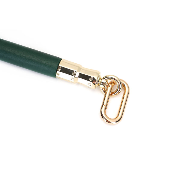 Gold carabiner on Mossy Chic leather spreader bar with eucalyptus core for BDSM restraint play