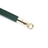 Close-up of Mossy Chic Leather Spreader Bar with green leather and gold hardware for BDSM restraint play