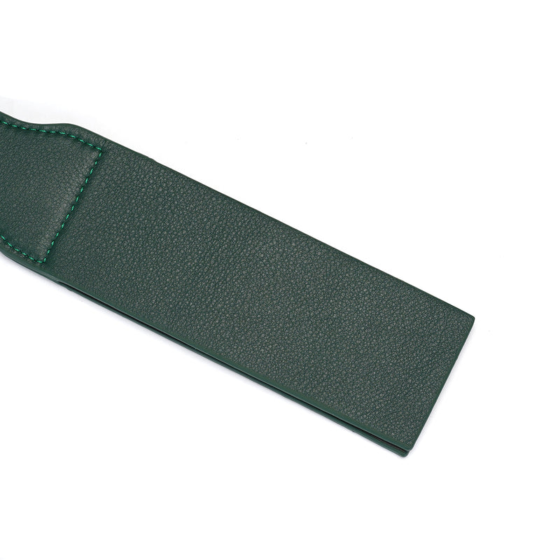 Mossy green leather spanking paddle featuring textured surface for impact play, part of the Mossy Chic bondage collection.