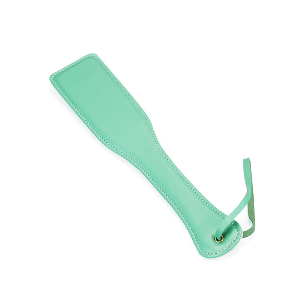 Light green leather spanking paddle from the Fairy collection with wrist strap for BDSM impact play and bondage kit enhancement