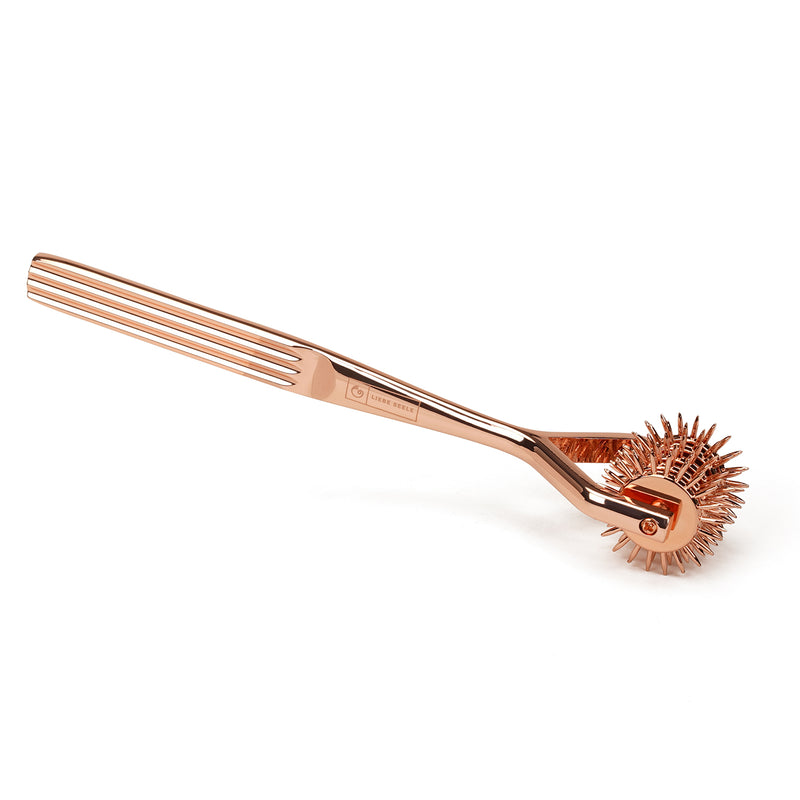 Rose gold five-row Wartenberg Pinwheel for sensory and impact play in BDSM, made of stainless steel