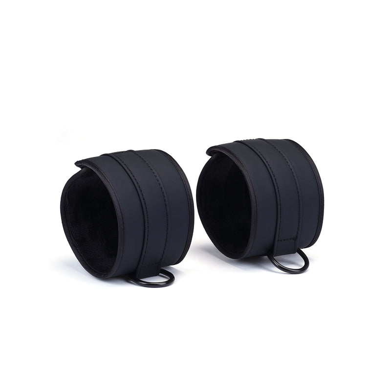 Vegan faux leather wrist cuffs with soft lining and metal D-rings for bondage play, part of the Vegan Fetish collection