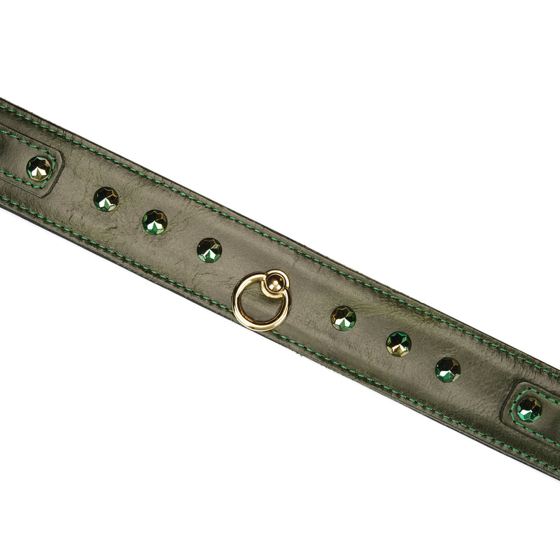 Close-up of luxury green leather collar with gemstone embellishments and central O-ring, perfect for bondage play
