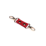 Red faux leather wrist cuff connector with metal clips for bondage play