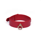 Red faux leather collar with metal ring for bondage play, adjustable size, presented on a plain white backdrop