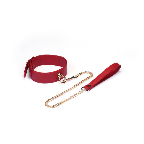 Red faux leather bondage collar with gold chain and handle for erotic play, adjustable size