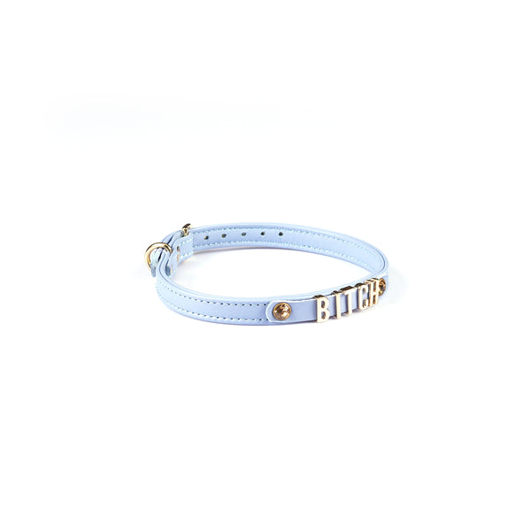 Light blue Italian leather choker with gold letters spelling BITCH and gemstone detail on white background