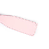 Pink leather spanking paddle from the Fairy collection with durable stitching, designed for bondage play