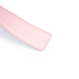 Pink leather spanking paddle from Fairy collection with white stitching, designed for bondage play