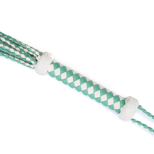 Close-up of white and green braided leather handle for the Fairy Leather Flogger Whip, featuring grip-enhancing knots