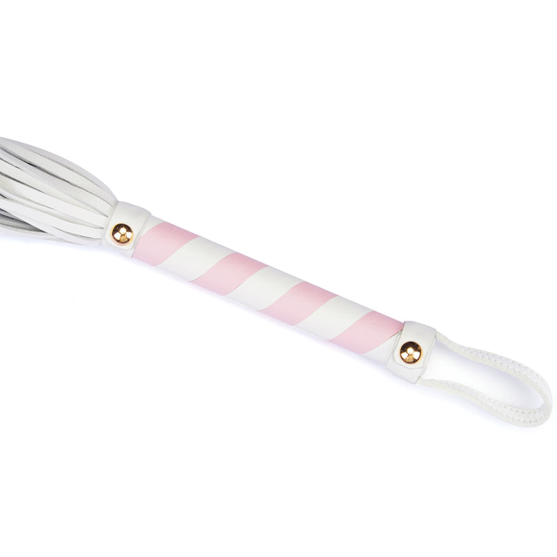 White and pink leather flogger whip from the Fairy collection, designed for light bondage play with rose gold accents and dual-toned leather handle