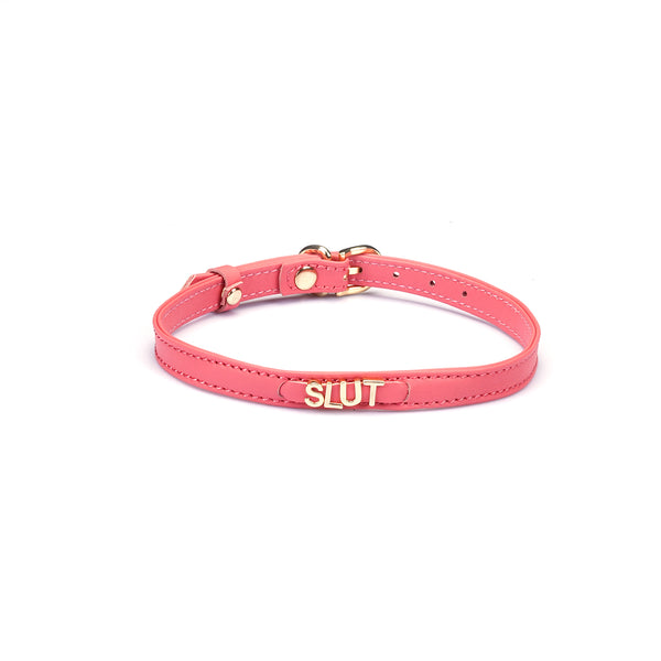 Liebe Seele pink Italian leather choker with gold letters spelling SLUT, featuring adjustable buckle for comfortable fit