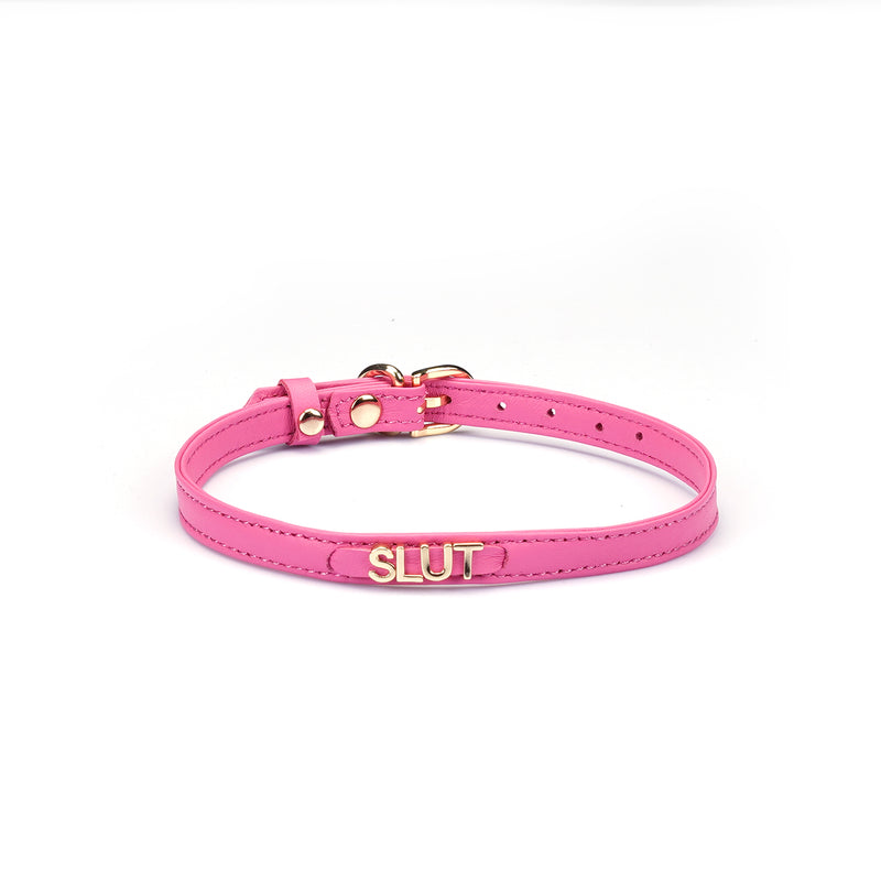 Liebe Seele Italian leather choker in bright pink with gold lettering spelling SLUT, adjustable buckle visible, fashion accessory for bondage
