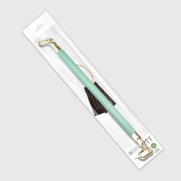 Fairy Green Leather-Coated Spreader Bar with rose gold accents in packaging, designed for elegant BDSM play