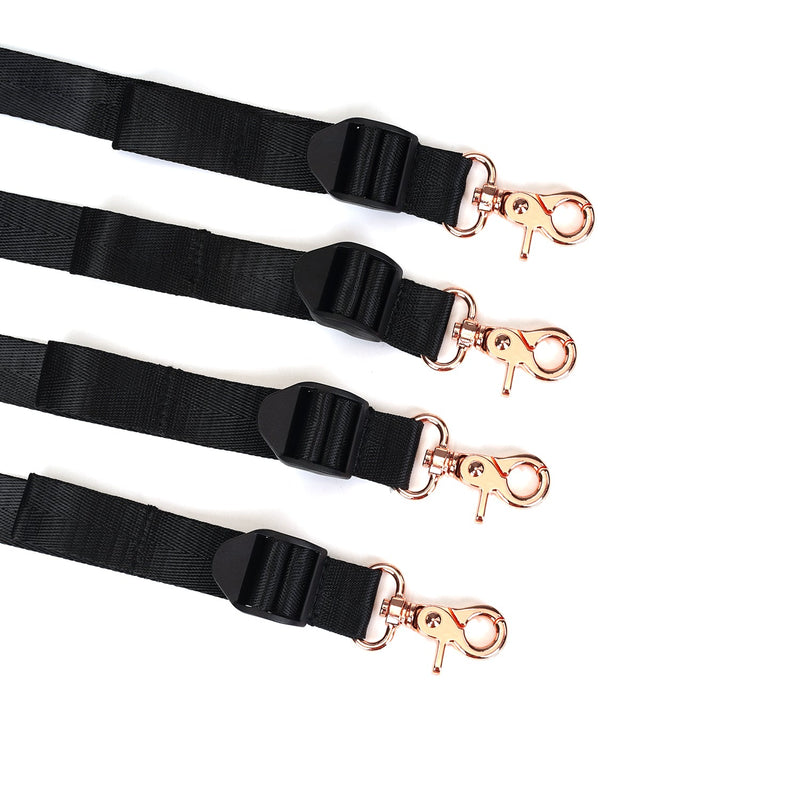 Under Mattress Restraint System with rose gold clips and adjustable black webbing belts for bedroom bondage