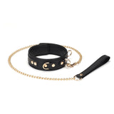 Black leather BDSM collar with golden chain leash from the Dark Secret collection, featuring adjustable buckles and D-rings for bondage play