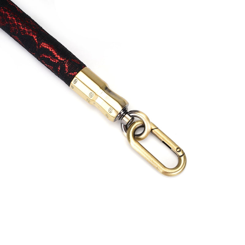 Close-up of Victorian Garden lace and vegan leather leg spreader bar with gold quick-release clip, illustrating the elegant design and compatibility with BDSM restraints