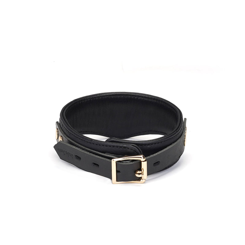 Large black leather bondage collar with ostrich skin pattern and gold buckle, part of the Demon's Kiss collection