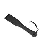 Black leather spanking paddle with ostrich skin pattern from Demon's Kiss collection, designed for luxurious impact play