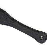 Black leather spanking paddle with ostrich skin pattern from the Angel's & Demon's Kiss Bondage collection