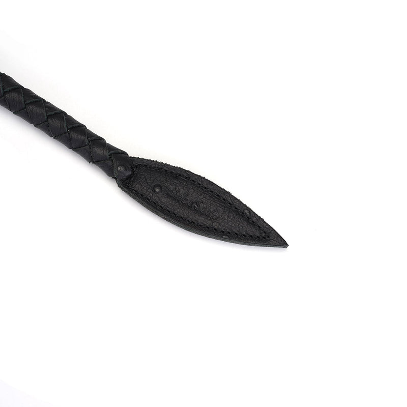 Close-up of black leather braided bullwhip tip, luxurious bondage accessory for impact play