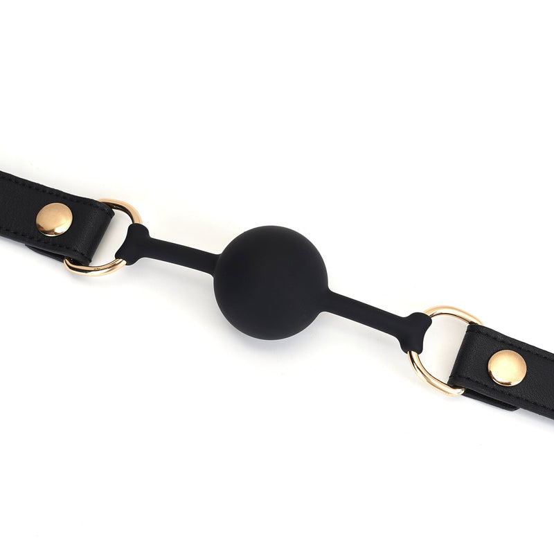 Black silicone ball gag with adjustable leather straps and golden buckles, designed for bondage play