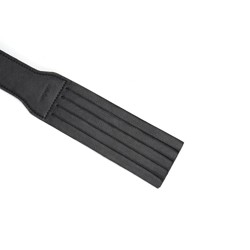 Black leather dual-sided spanking paddle for BDSM play, featuring precise groove detailing for diverse tactile sensations