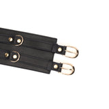 Close-up of black leather bondage belt with golden buckles, adjustable feature highlighted, part of the Dark Secret collection