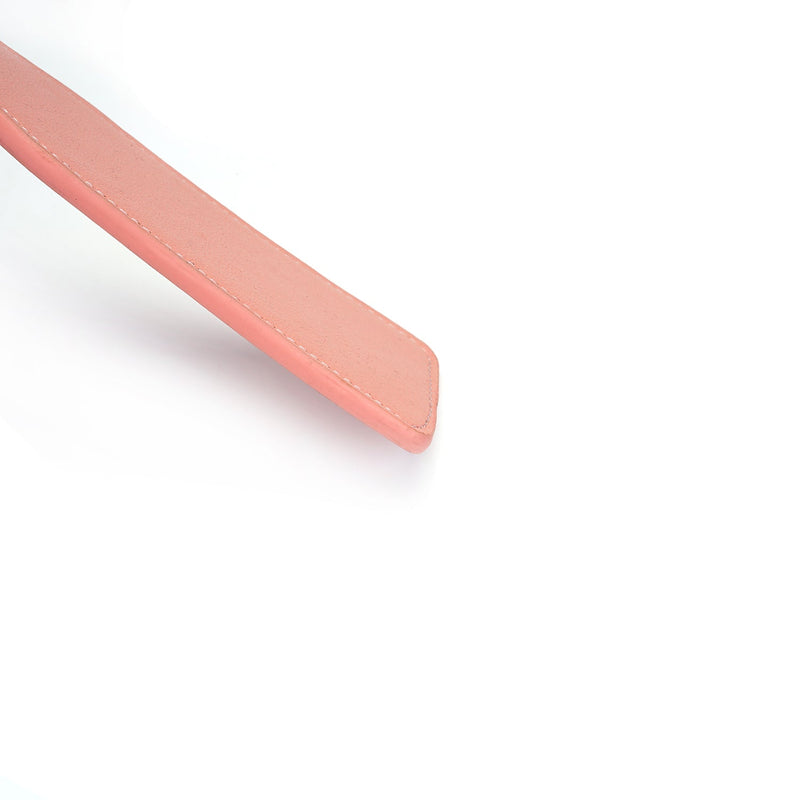 Close-up of Pink Dream leather spanking paddle in bubblegum pink, ideal for beginner's bondage play.
