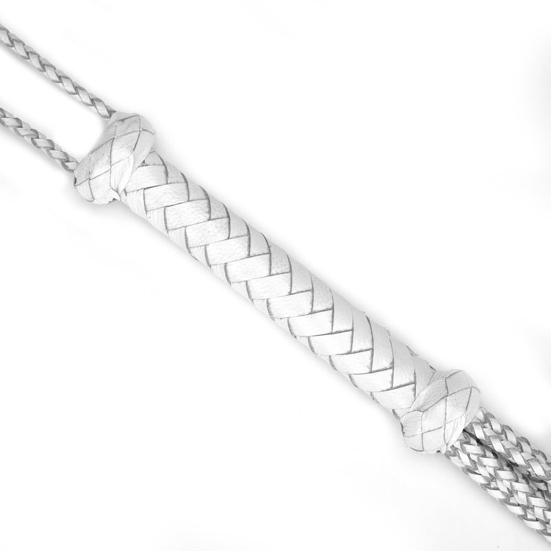 Close-up of white leather cat o' nine tails whip with braided handle for BDSM impact play, part of the Fuji White collection