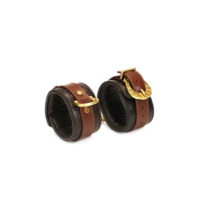 Luxury dark brown leather handcuffs with vintage gold hardware from The Equestrian collection, designed for comfortable and secure bondage play